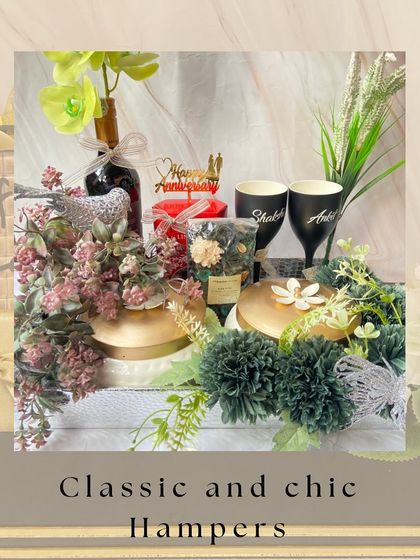 Classic and chic hampers for any occasion. This anniversary gift features a beautiful floral arrangement, personalized wine glasses, and other elegant items for a timeless feel.
