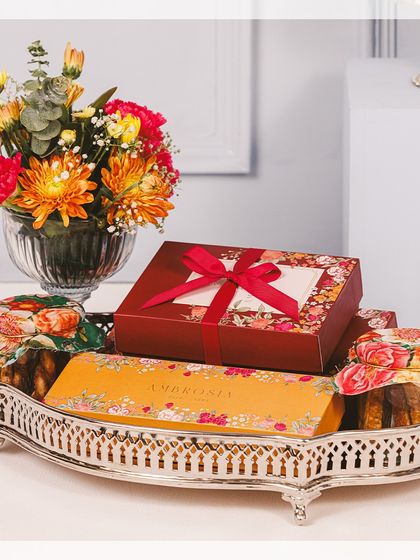 A majestic silver tray filled with our Diwali bestsellers. This large hamper includes beautifully boxed sweets, jars of our signature cookies, and a fresh floral arrangement to complete the festive look.
