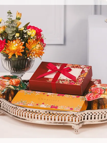 A majestic silver tray filled with our Diwali bestsellers. This large hamper includes beautifully boxed sweets, jars of our signature cookies, and a fresh floral arrangement to complete the festive look.