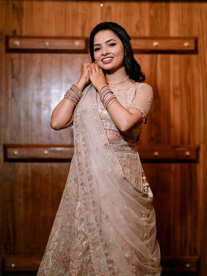 Adjusting her earrings before the event. I love these little moments that show the bride's excitement. Her makeup is soft and pretty, perfect for an engagement.