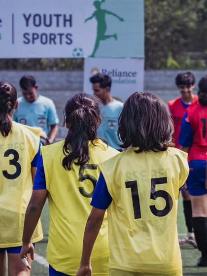 The pre-match lineup, a moment of focus and unity. Our U15 girls team walks onto the pitch for the Reliance Foundation Young Champs Football Cup.