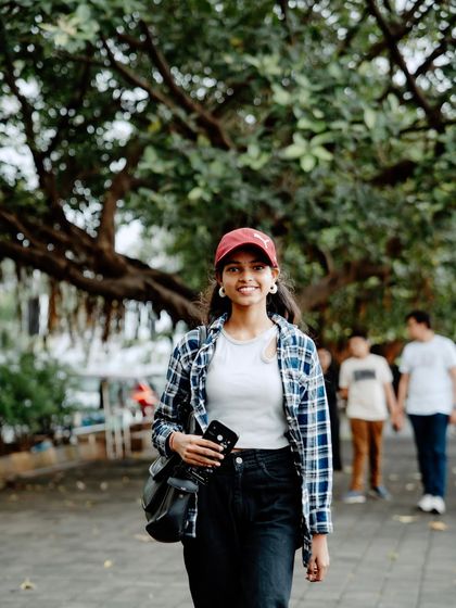 A happy, confident portrait. The combination of the casual outfit and the natural setting makes this photo feel very approachable and real.
