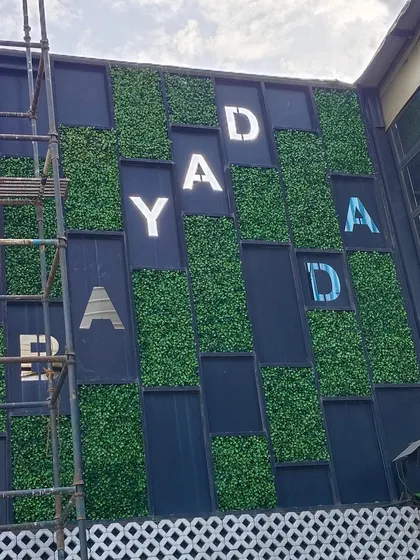 We work with businesses to integrate their branding into green designs. For the Bombay Adda facade, we installed custom-cut artificial grass panels to create a memorable and eye-catching entrance.