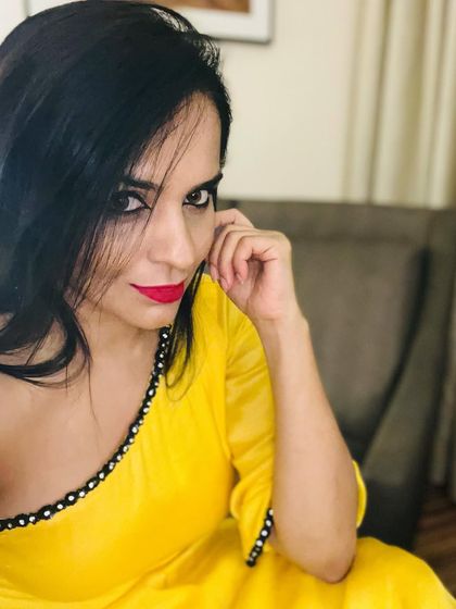 I love the sunny vibe of this yellow outfit. The neckline is detailed with delicate mirror work, adding a touch of traditional craft to a modern, bright color.