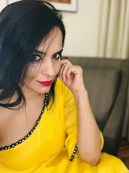 I love the sunny vibe of this yellow outfit. The neckline is detailed with delicate mirror work, adding a touch of traditional craft to a modern, bright color.