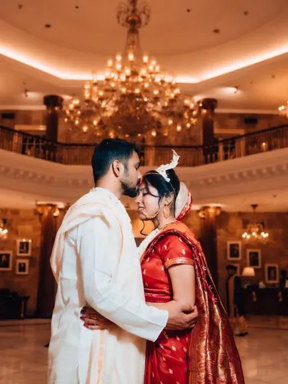A quiet moment of togetherness in a grand, beautifully lit hall. We excel at using dramatic lighting and stunning venues to create timeless, cinematic portraits that feel like a scene from a movie.