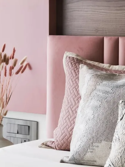 A close-up on the bed, showcasing the beautiful textures and layering of pillows and fabrics in the master bedroom.