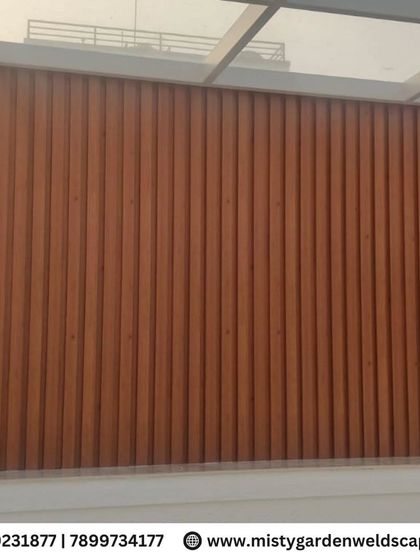 A full view of the WPC louver wall, showcasing its clean vertical lines and rich wood-like texture.