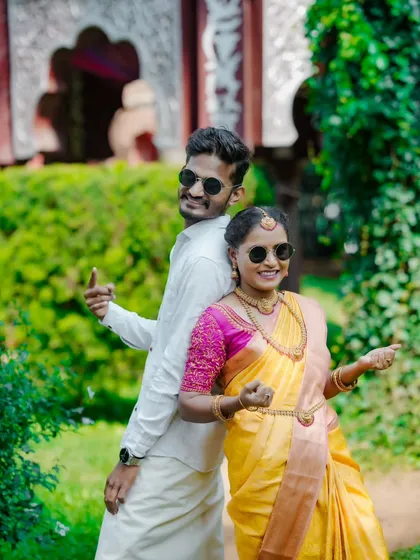 Fun and stylish! This couple adds a modern twist to their traditional look with sunglasses, creating a playful pre-wedding photo.