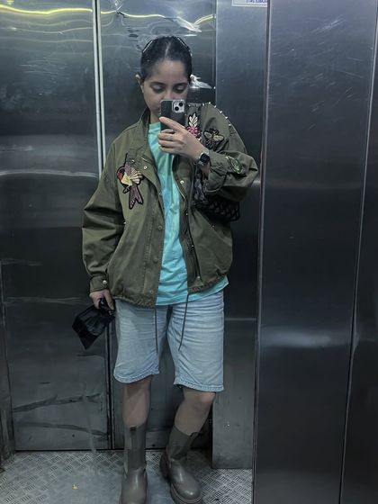 An olive green utility jacket I customized with embroidered patches. This shows how even a few well-placed artistic details can elevate a simple piece into something personal and unique.