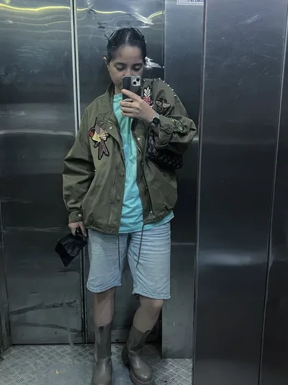An olive green utility jacket I customized with embroidered patches. This shows how even a few well-placed artistic details can elevate a simple piece into something personal and unique.