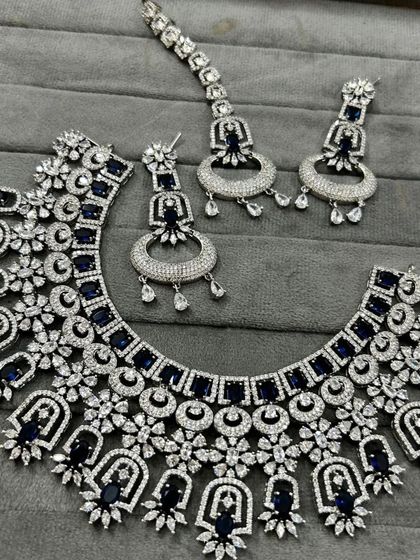 A closer look at the blue and white stone necklace set. The intricate design gives it a rich, heavy look, perfect for a bride's reception or a sangeet night.