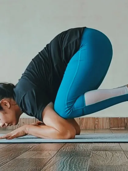 This is the Baby Crow Pose, an excellent preparation for the full Crow Pose. It builds forearm and shoulder strength and helps you get used to the feeling of balancing on your arms.