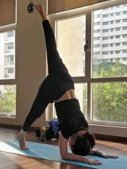 Exploring a split-leg variation in Pincha Mayurasana. Inversions like this energize the body, calm the nervous system, and offer a new perspective by reversing the flow of gravity.