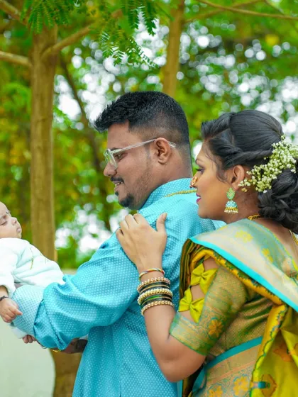 A tender moment between new parents and their baby during an outdoor shoot. These natural, candid shots are often the most treasured.