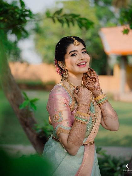 A joyful, candid photo of Nidhi. My goal is always to create a look that allows the bride's personality to shine through.