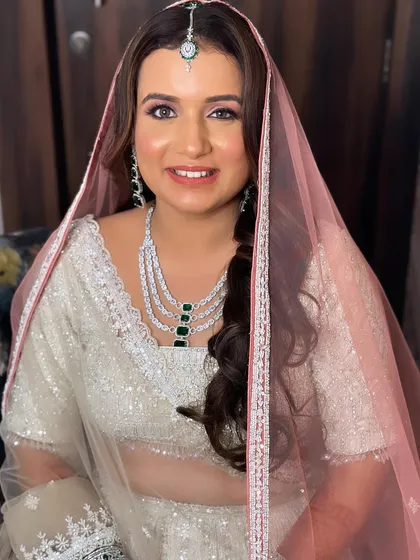 The full look with the veil. The makeup shines through, creating a look that is both traditional and modern.