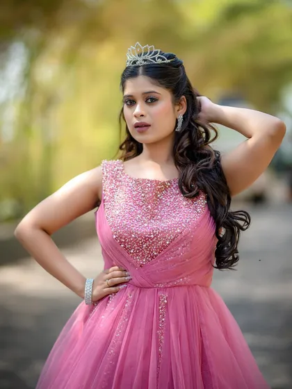 A model looking fierce and beautiful in a pink gown, ready for a pre-wedding or reception style photoshoot.