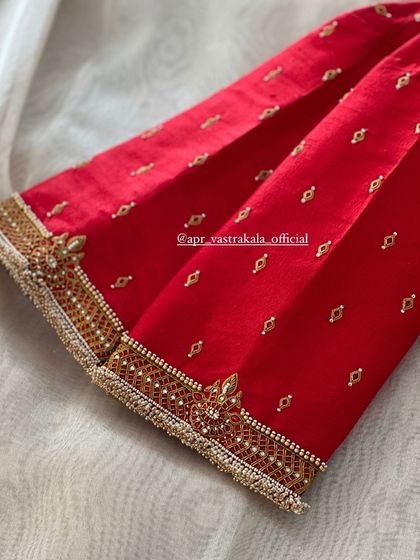 The scattering of small butis adds a subtle sparkle to this red blouse.