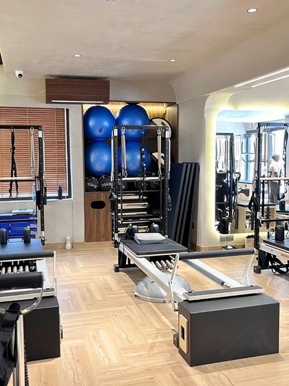 Our studio is a blend of cutting edge equipment and a calm, focused environment. Here you can see our reformers, stability balls, and storage for a clean workout space.