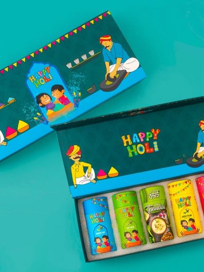A beautifully illustrated Holi gift box containing five tubes of herbal gulal and thandai mix. The artwork on the box depicts the joyful spirit of the festival.