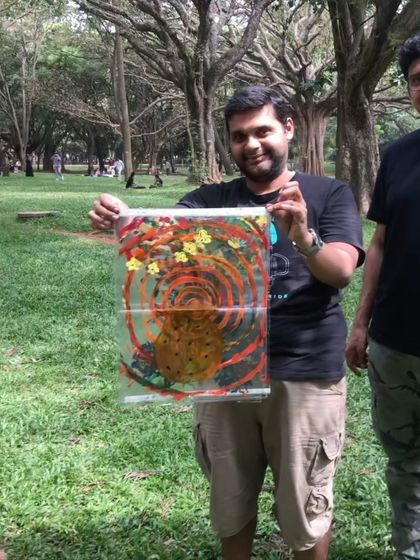 A participant proudly displaying his finished artwork from our community circle. It's wonderful to see what emerges from these sessions.
