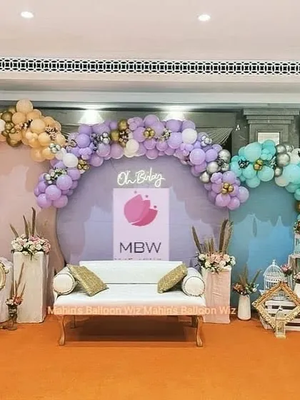 A large-scale "Oh Baby" stage with three arched backdrops in different pastel colors. This setup is perfect for a grand baby shower or naming ceremony.
