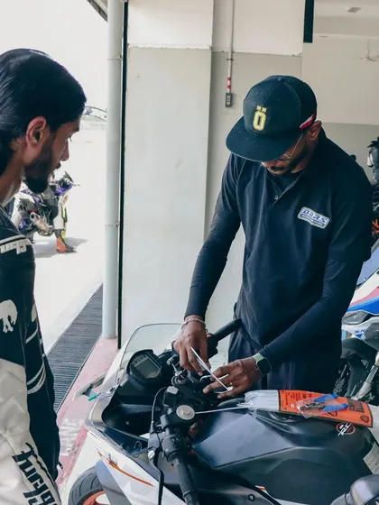 An instructor helps a rider set up the telemetry equipment on their bike. We ensure everything is calibrated correctly to capture accurate data for analysis.