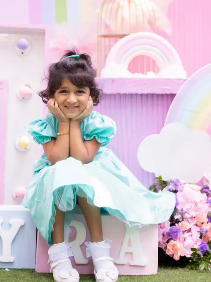 Another cute shot of the birthday girl at her rainbow party, full of smiles.
