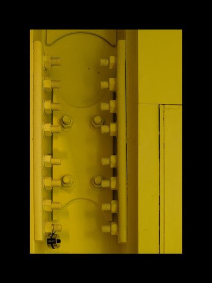 A detail shot of the bolted steel connections at MAP, painted in a vibrant yellow. We believe in showing the "bones" of a building, celebrating the engineering and construction that are integral to the final architectural expression.