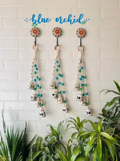 Our 'Symphony Chimes' in the 'Blue Orchid' color combination. This bunch of four small ceramic bells with macrame knots and colorful beads comes with a ceramic hook for easy installation.