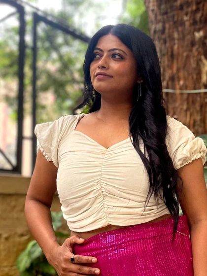 A trendy and chic fusion look. This client is wearing a simple ruched crop top paired with bright pink sequined pants that I designed.