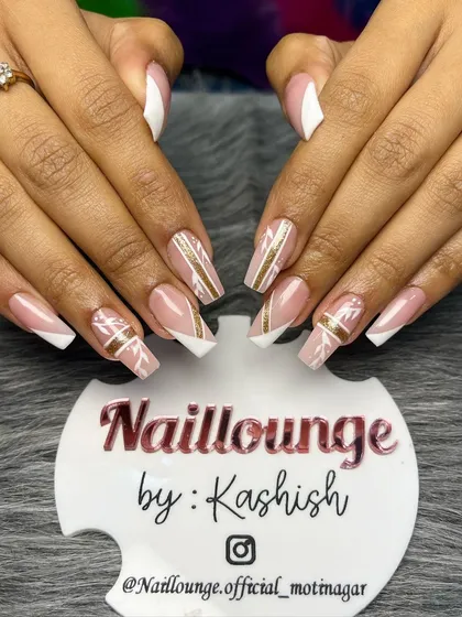 A beautiful and intricate design with a nude base, white V-tips, and hand-painted gold and white patterns.
