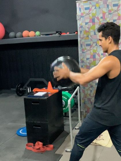 A rotational medicine ball throw, demonstrating the full-body coordination required to generate maximum power.