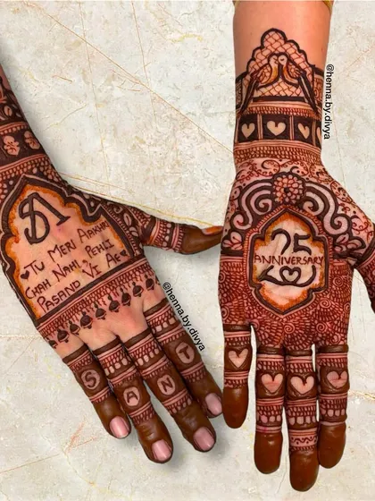 A special design to celebrate a 25th anniversary. It includes a personal message in Punjabi script, the number '25', and the name 'Sant' spelled out on the fingers.