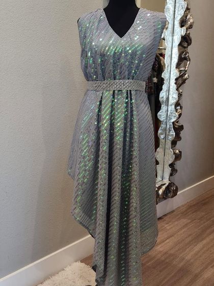 A modern, asymmetrical dress in a shimmering grey fabric. The diagonal sequins catch the light beautifully, and the belted waist creates a flattering silhouette.