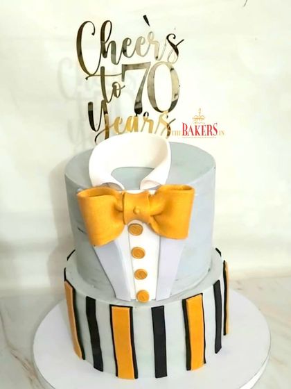 Celebrating 70 in style with an elegant two-tier tuxedo theme cake. This minimal fondant design in grey and gold was for Aditi's father's birthday. The flavor was a delicious vanilla with mixed berries and cream cheese.