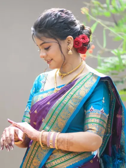 A candid moment showing the bride's soft smile and the delicate details of her makeup and hair.