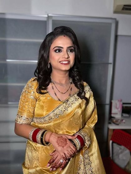 A smiling portrait of the bride at her reception. The soft curls and glowing makeup make for a timeless and beautiful look.