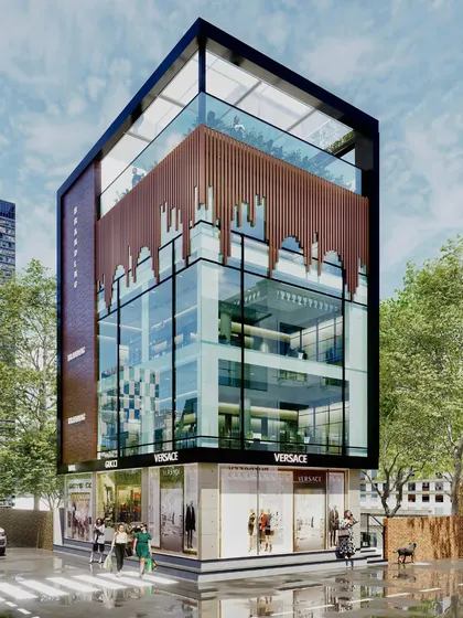 Our expertise extends to modern commercial architecture. This corner plot commercial building in JP Nagar features a sleek glass facade and distinctive wooden louvres, designed to create a landmark with high-visibility retail spaces and collaborative office zones.