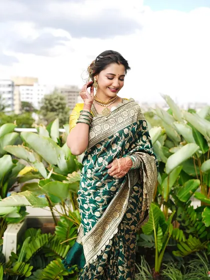 A lovely candid shot. The soft makeup and elegant saree create a look of timeless beauty and effortless grace.