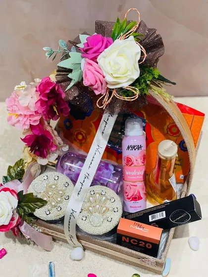 Sway her mood and make her smile with this amazing personalized gift hamper. It features Nykaa and MAC cosmetics, beautifully arranged in a decorative tray with flowers.