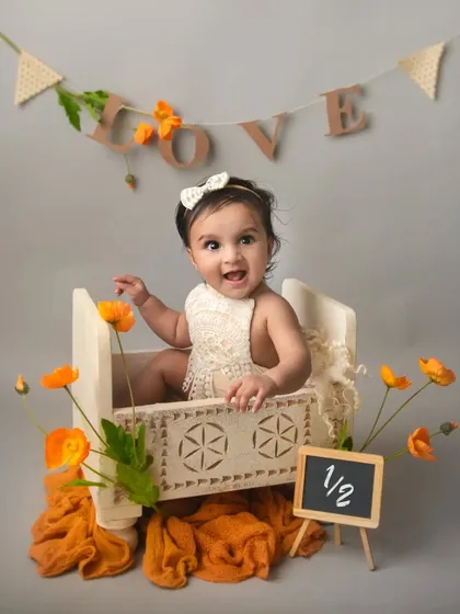 Celebrating a half-birthday. Sitter sessions are a wonderful way to mark these fun milestones. This little girl's happy expression is absolutely priceless.