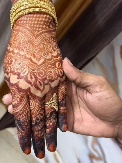 A close-up of the bride's hand, showing the beautiful stain.