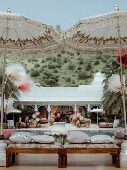 Ornate, custom-made umbrellas provide shade and a touch of royal elegance to this outdoor Haldi setup. Every element is chosen to enhance the theme and the guest experience.