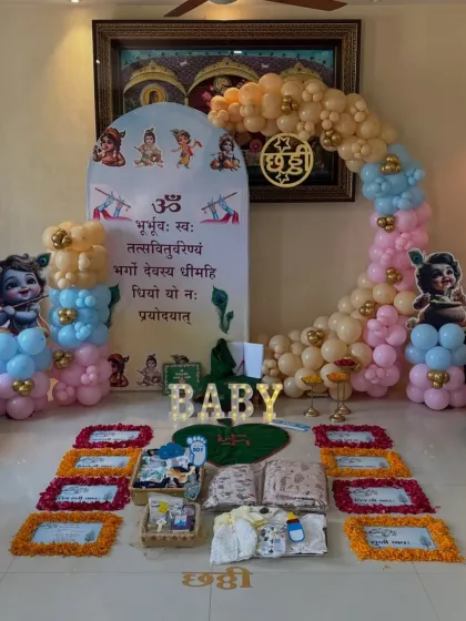 We design decorations that honor your family's traditions. This is a setup for a Chhathi ceremony, incorporating sacred elements like the Gayatri Mantra on the backdrop, marigold flower arrangements, and Bal Krishna motifs for a blessed celebration.