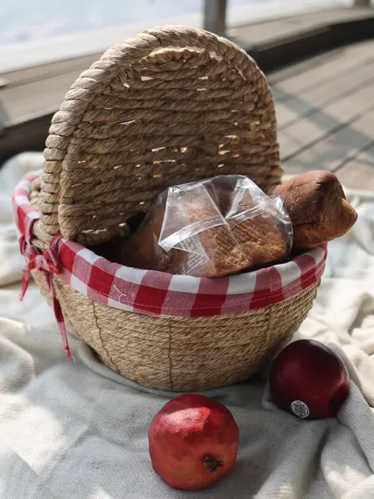 Our versatile baskets do it all, from picnic hampers to home decor. This classic picnic basket with a red gingham lining is perfect for a day out or for charming storage at home.