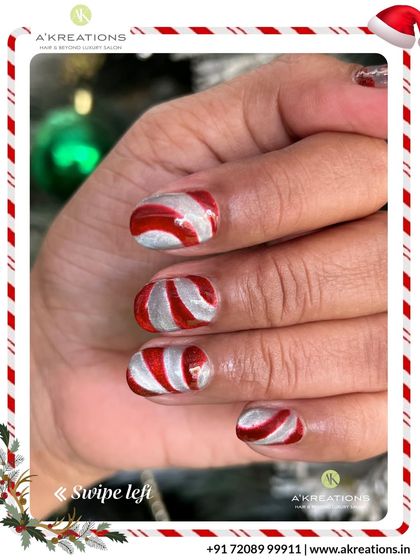 Sweet and festive candy cane nail art, featuring swirling red and silver stripes that capture the fun and magic of the holiday season.