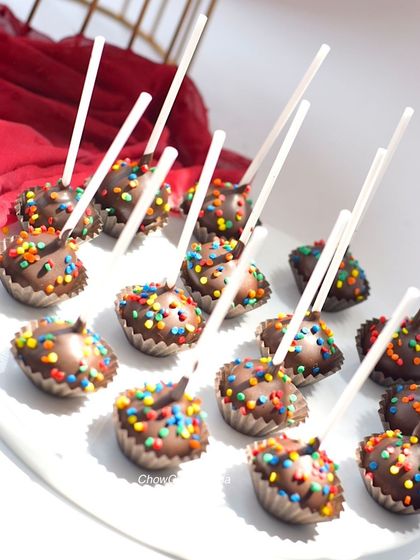 A close-up of the chocolate cake pops covered in colourful sprinkles. These are always a hit at birthday parties.