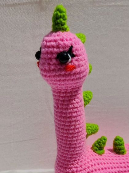 A close-up on Mrs. Dino's sweet, hand-stitched face.